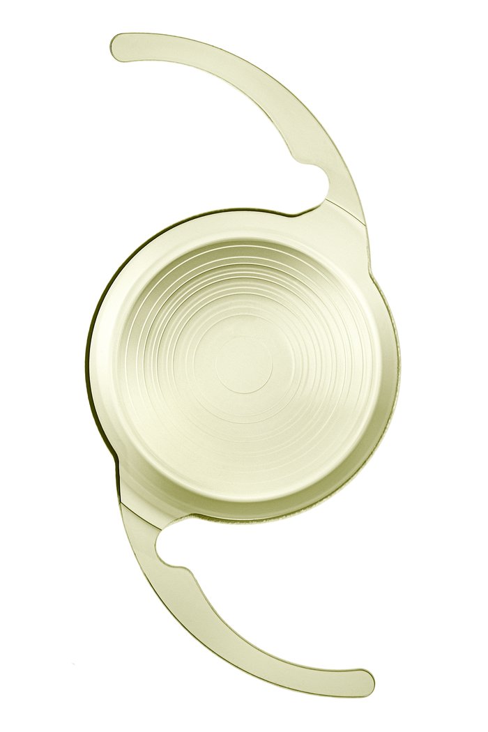 TECNIS Odyssey intraocular lens on a white background, showing the concentric echelette rings on the central optic and the two haptics